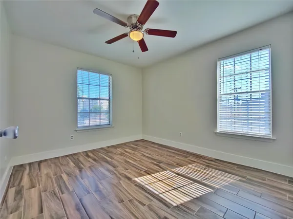 wooden floor in an empty room with a window