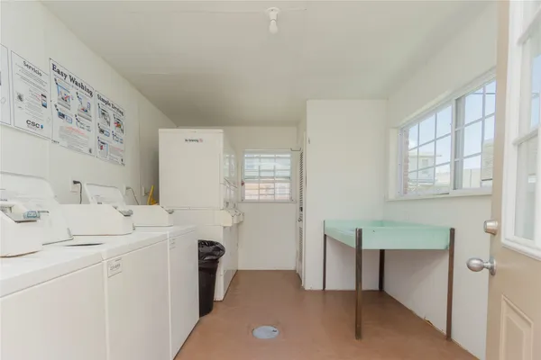 a utility room with cabinets washer and dryer