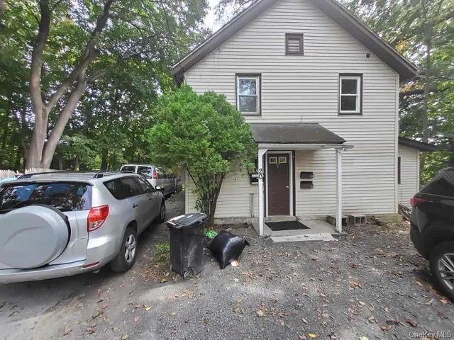 a view of a house with a backyard space and sitting area