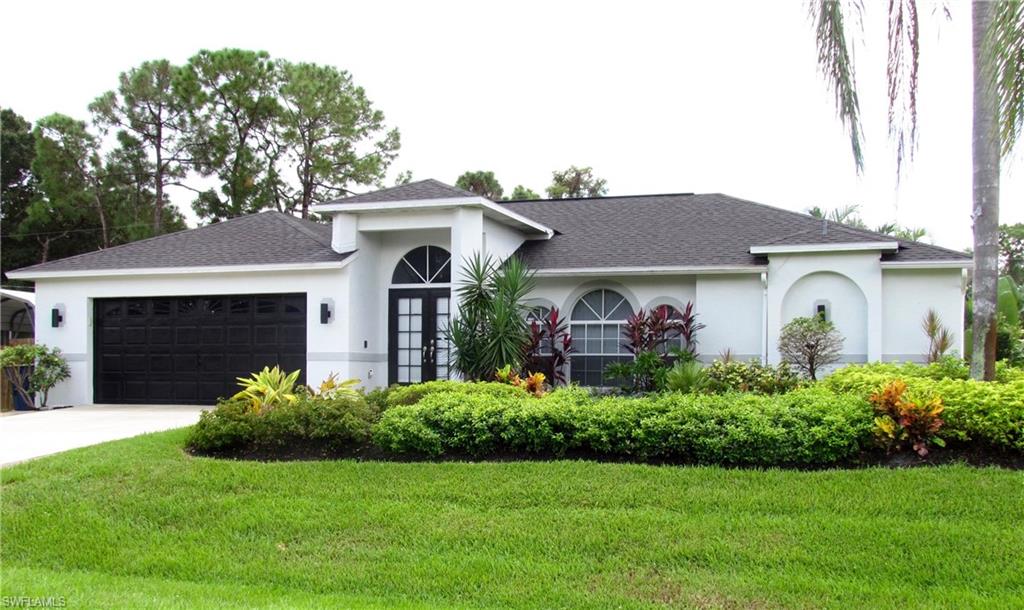 9124 Morris Road Fort Myers, FL 33967 - Photo 1 of 29 a front view of a house with a garden and plants