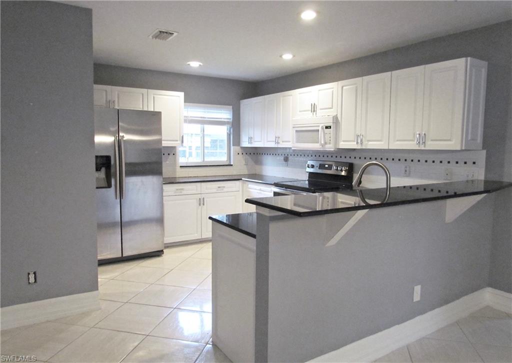 9124 Morris Road Fort Myers, FL 33967 - Photo 13 of 29 a kitchen with a sink cabinets and stainless steel appliances