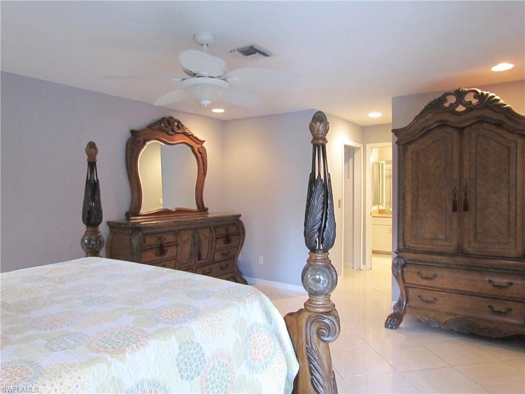 9124 Morris Road Fort Myers, FL 33967 - Photo 18 of 29 a bedroom with a bed and a dresser