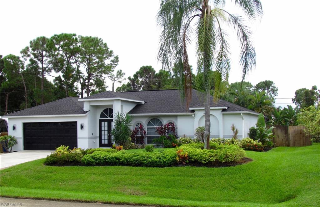 9124 Morris Road Fort Myers, FL 33967 - Photo 2 of 29 a view of a white house with a yard and potted plants