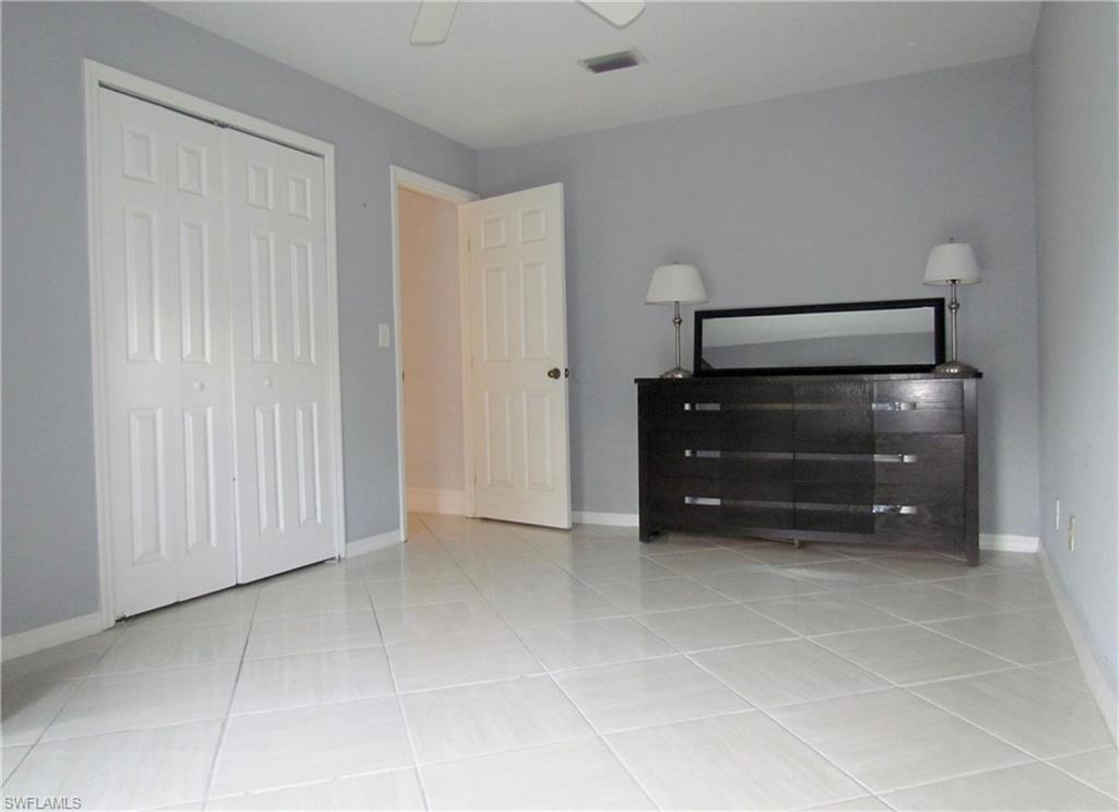 9124 Morris Road Fort Myers, FL 33967 - Photo 21 of 29 a room with a cabinets and a ceiling fan