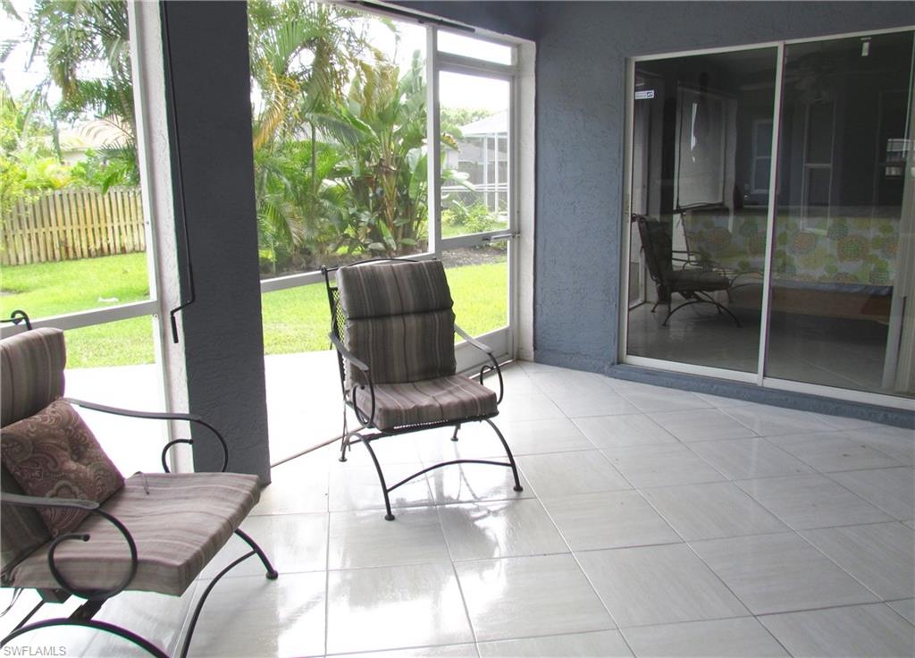 9124 Morris Road Fort Myers, FL 33967 - Photo 26 of 29 a living room with furniture and a floor to ceiling window