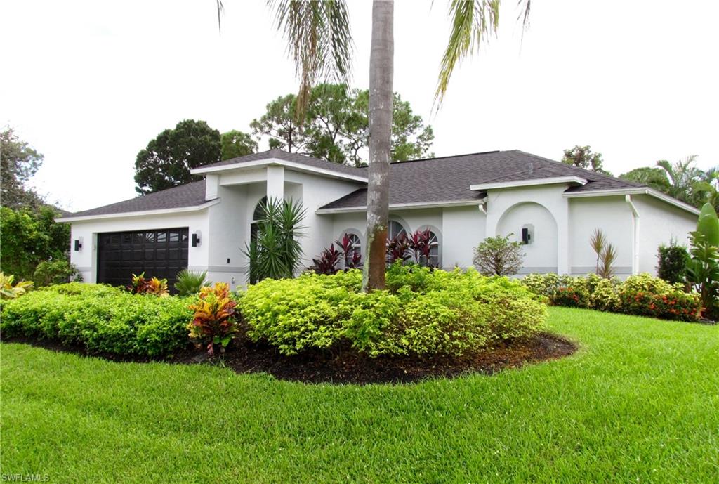 9124 Morris Road Fort Myers, FL 33967 - Photo 3 of 29 a front view of a house with a garden
