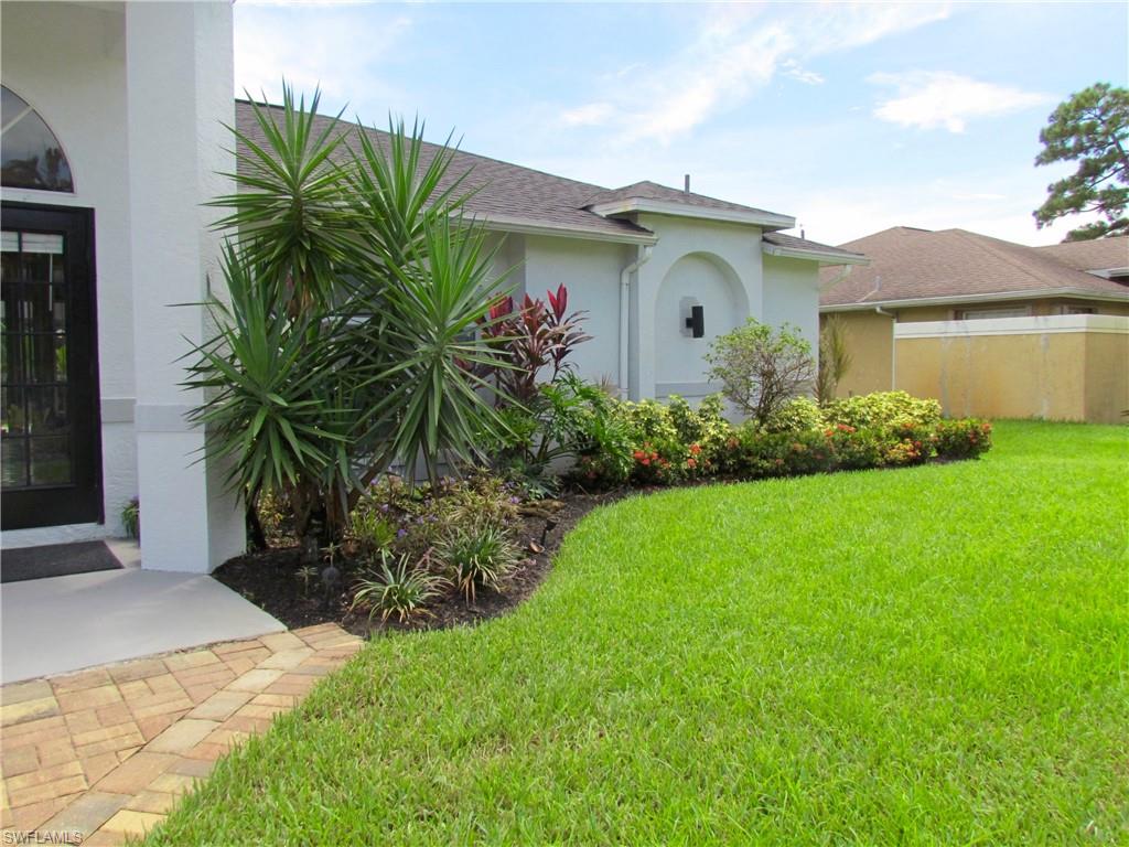9124 Morris Road Fort Myers, FL 33967 - Photo 6 of 29 a front view of a house with a garden