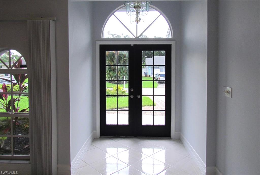 9124 Morris Road Fort Myers, FL 33967 - Photo 8 of 29 stairs view of an empty room with a window
