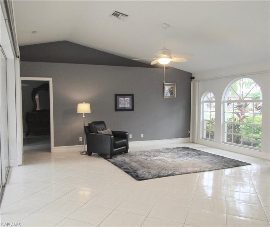 9124 Morris Road Fort Myers, FL 33967 - Photo 9 of 29 a spacious bedroom with a bed and a chandelier