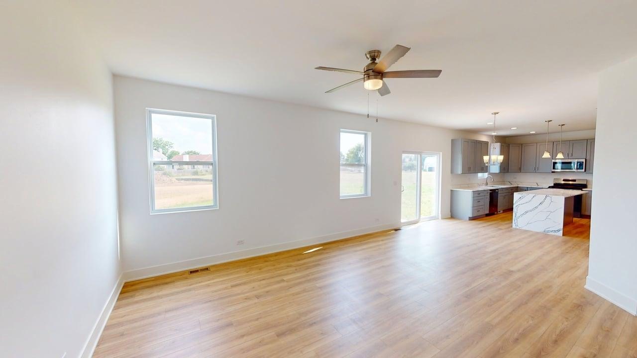 784 Cascade Place Marengo, IL 60152 - Photo 13 of 33 a view of an empty room with wooden floor and a window