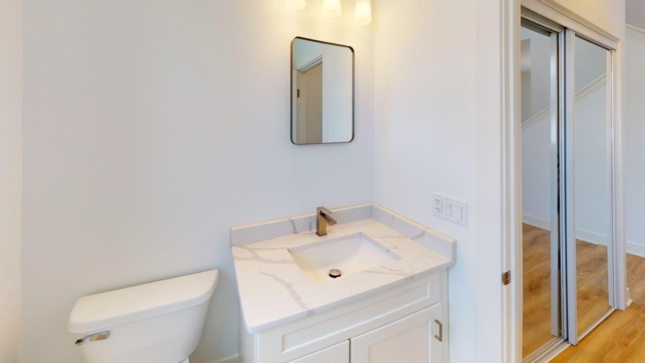 784 Cascade Place Marengo, IL 60152 - Photo 14 of 33 a bathroom with a toilet sink and mirror
