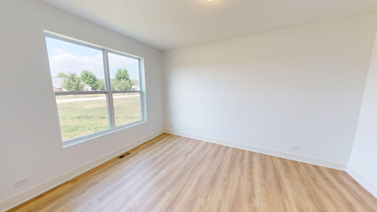 784 Cascade Place Marengo, IL 60152 - Photo 16 of 33 an empty room with wooden floor and windows