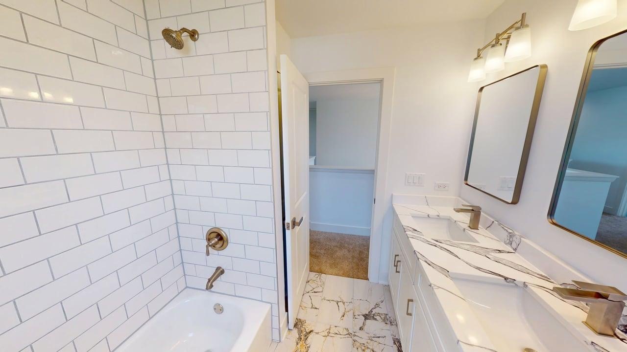 784 Cascade Place Marengo, IL 60152 - Photo 29 of 33 a bathroom with a tub sink and mirror