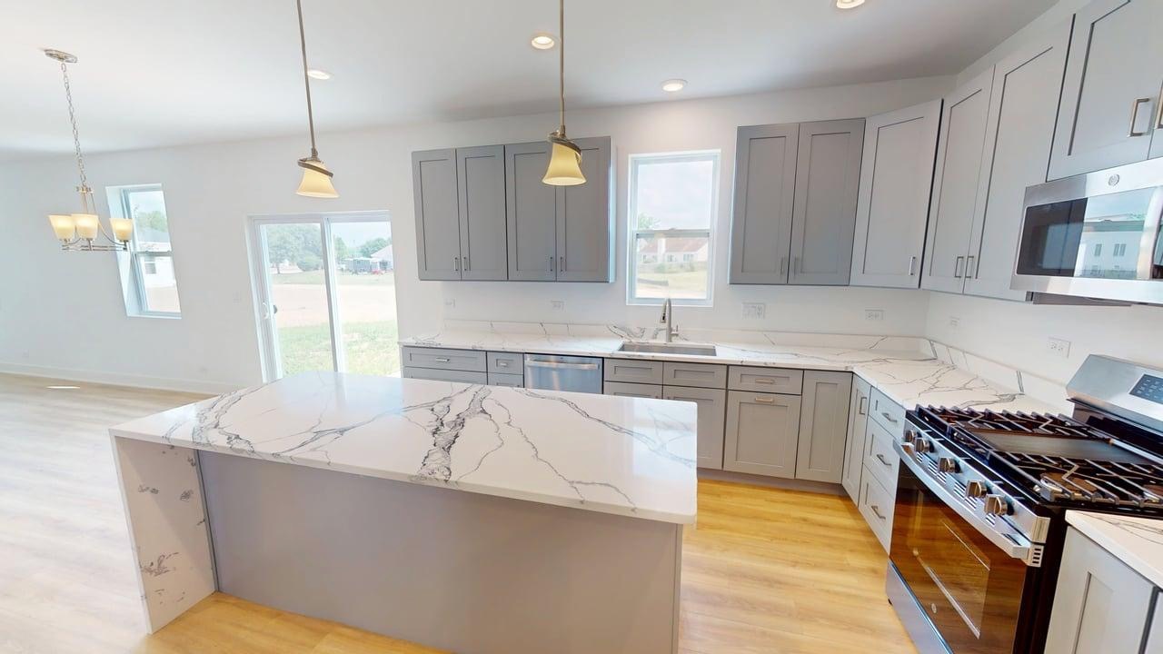 784 Cascade Place Marengo, IL 60152 - Photo 6 of 33 a kitchen with stainless steel appliances granite countertop a sink a stove and a wooden floors