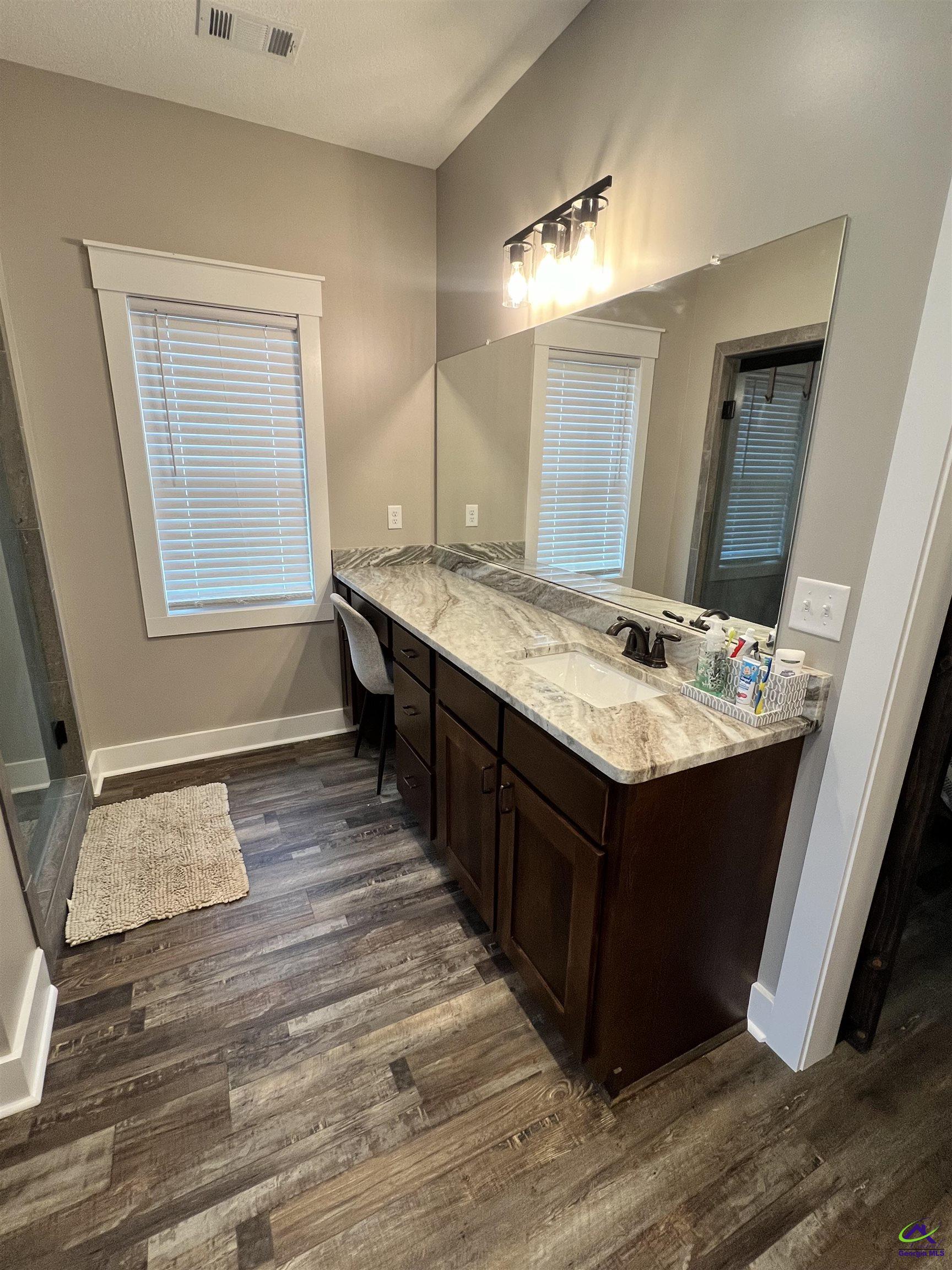 2203 Old Macon Road Montrose, GA 31065 - Photo 30 of 64 a bathroom with a sink vanity granite tub and a mirror