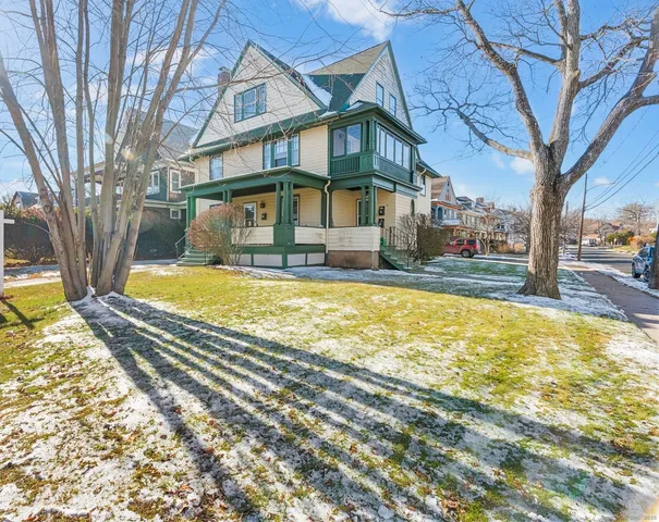 a view of a house with a yard covered with snow