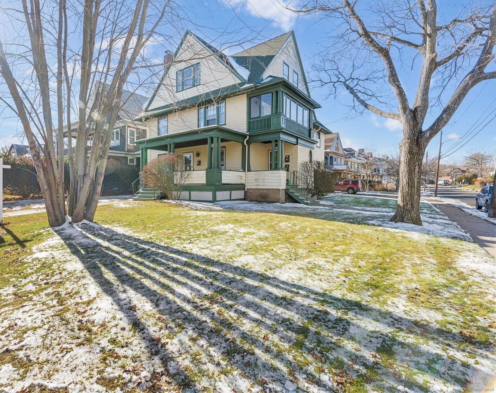 a view of a house with a yard covered with snow