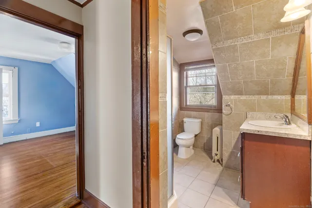 a bathroom with a toilet sink and mirror