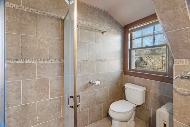 a white toilet sitting next to a bathroom sink