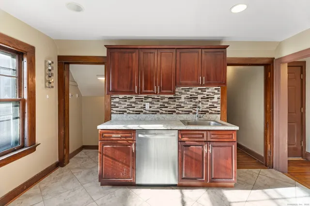 a kitchen with stainless steel appliances granite countertop wooden cabinets and a counter top space