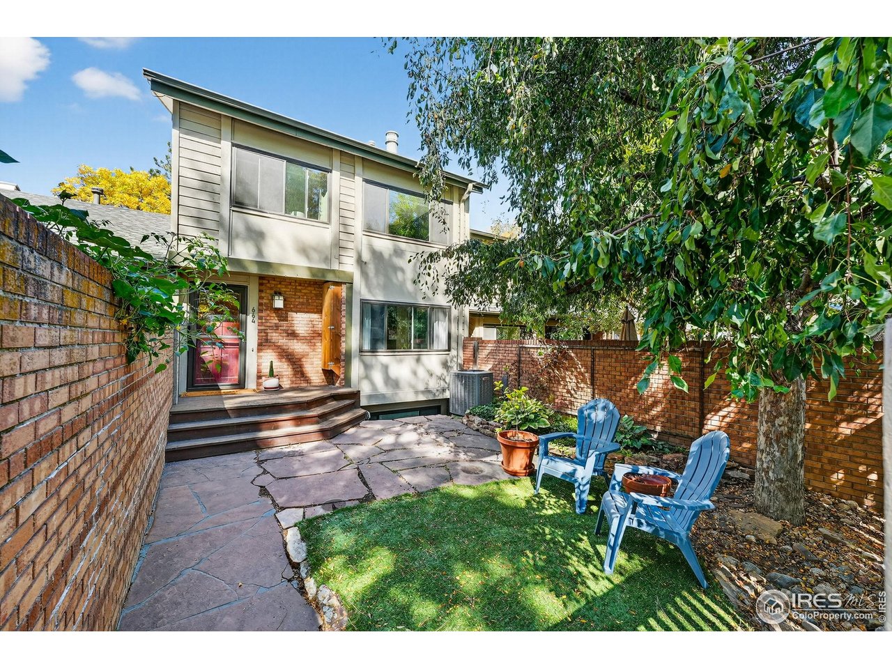 a view of a patio with table and chairs and potted plants