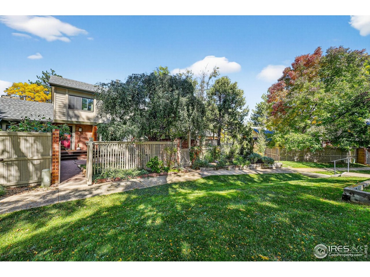 664 Quince Circle Boulder, CO 80304 - Photo 4 of 15 a backyard of a house with table and chairs