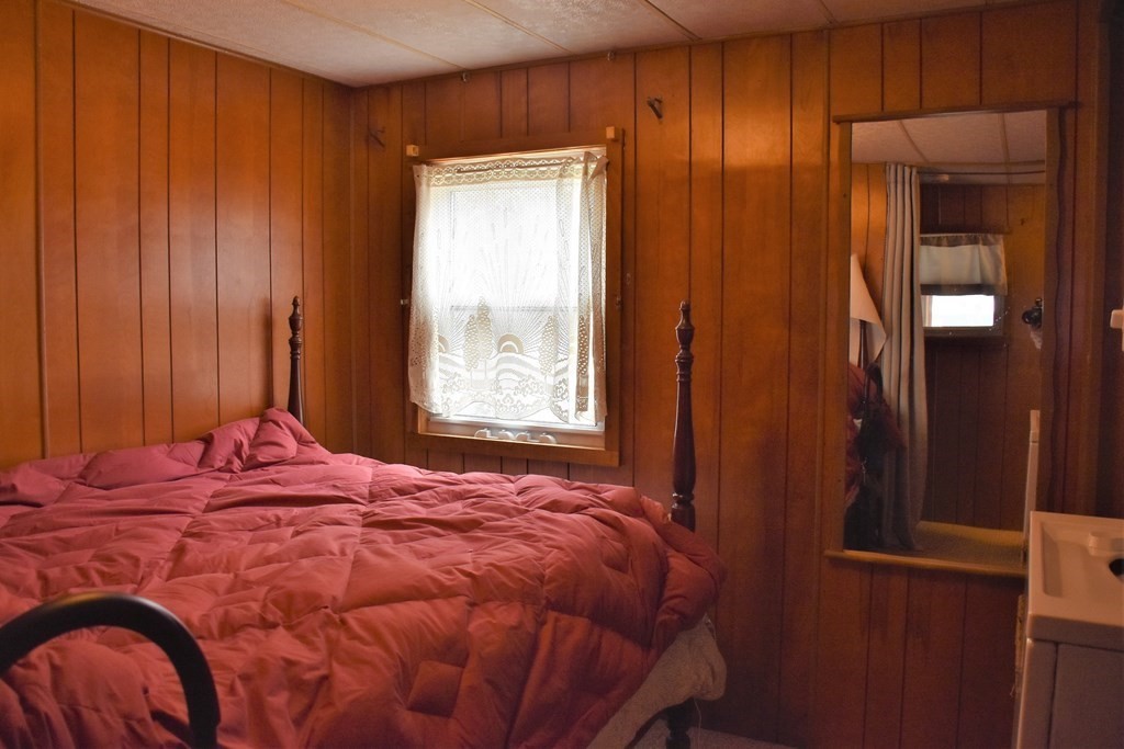 67 Breezy Lane Thompson, CT 06262 - Photo 11 of 17 a bed sitting in a bedroom next to a window and a bathroom