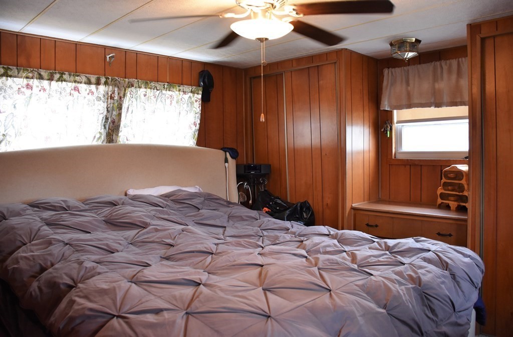 67 Breezy Lane Thompson, CT 06262 - Photo 13 of 17 a bedroom with a bed and a chandelier