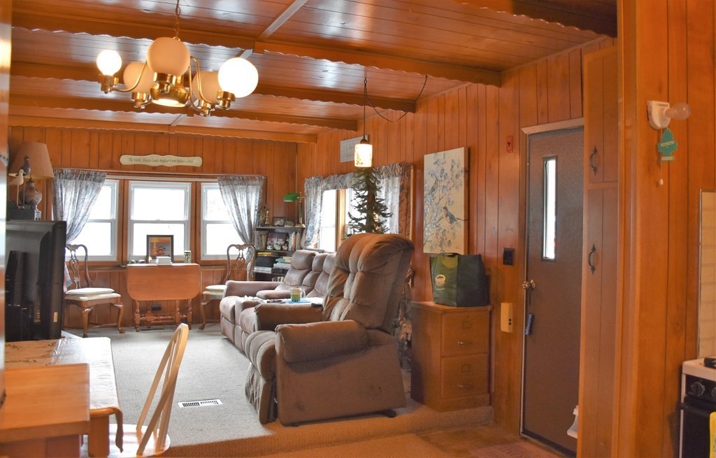 67 Breezy Lane Thompson, CT 06262 - Photo 5 of 17 a living room with furniture a chandelier and a large window