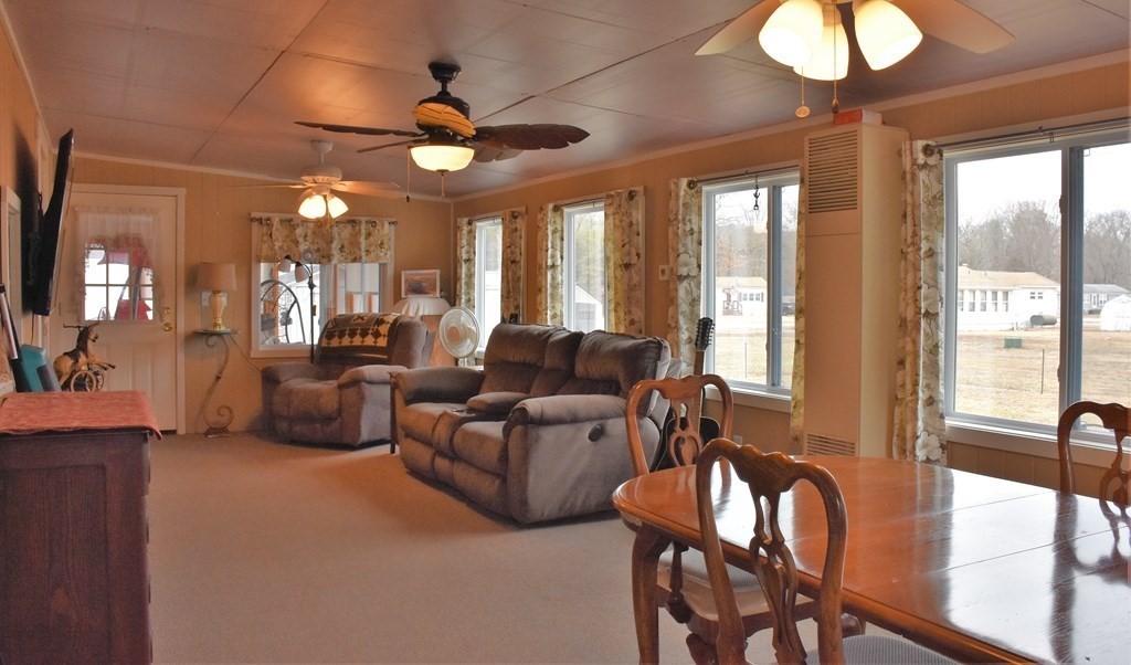 67 Breezy Lane Thompson, CT 06262 - Photo 8 of 17 a living room with furniture a chandelier and a large window