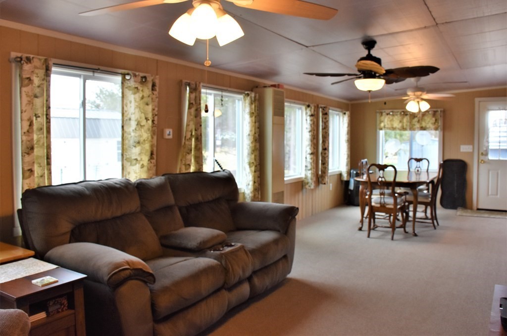 67 Breezy Lane Thompson, CT 06262 - Photo 9 of 17 a living room with furniture a chandelier and a large window