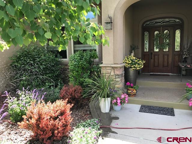 850 Southeast Pinyon Street Cedaredge, CO 81413 - Photo 45 of 45 a front view of a house with a flower garden