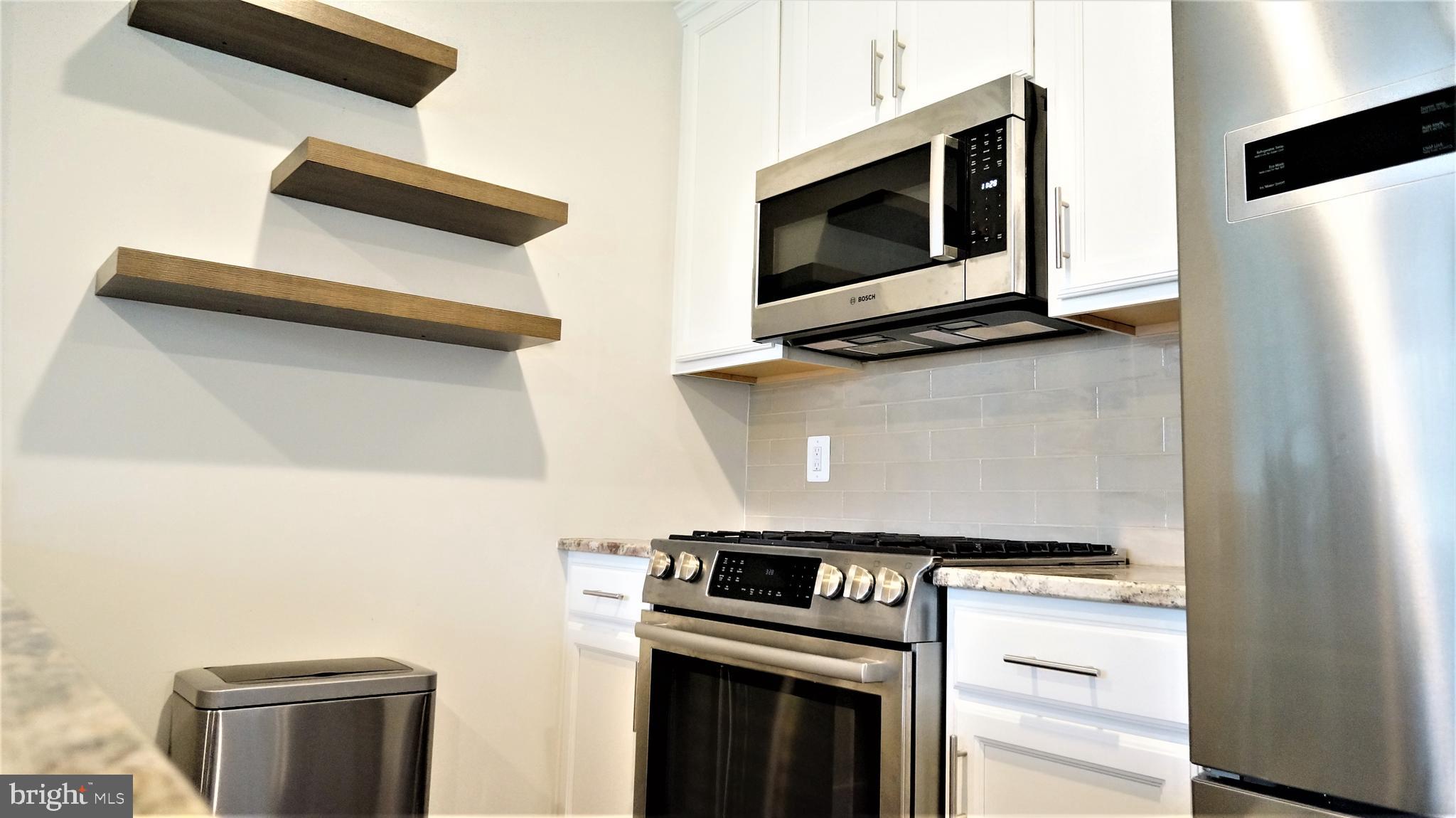 1951 Reston Vly Way, Unit 10 Reston, VA 20191 - Photo 13 of 50 a kitchen with a stove and a microwave