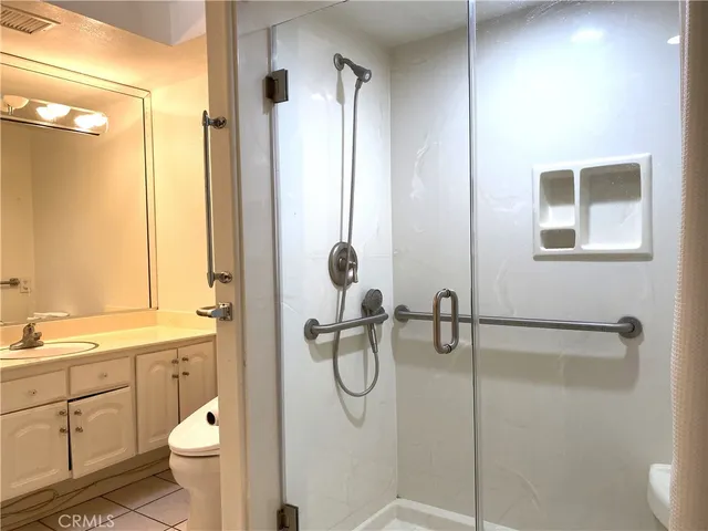 a bathroom with a granite countertop sink toilet and shower