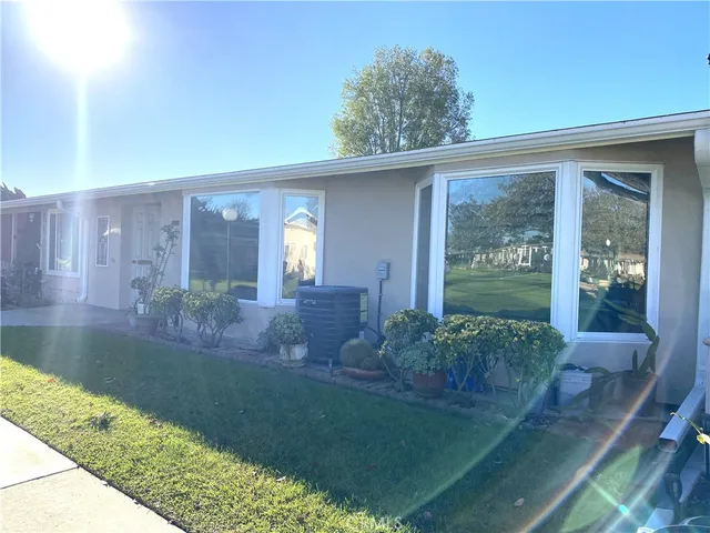 a view of backyard with plants and outdoor seating