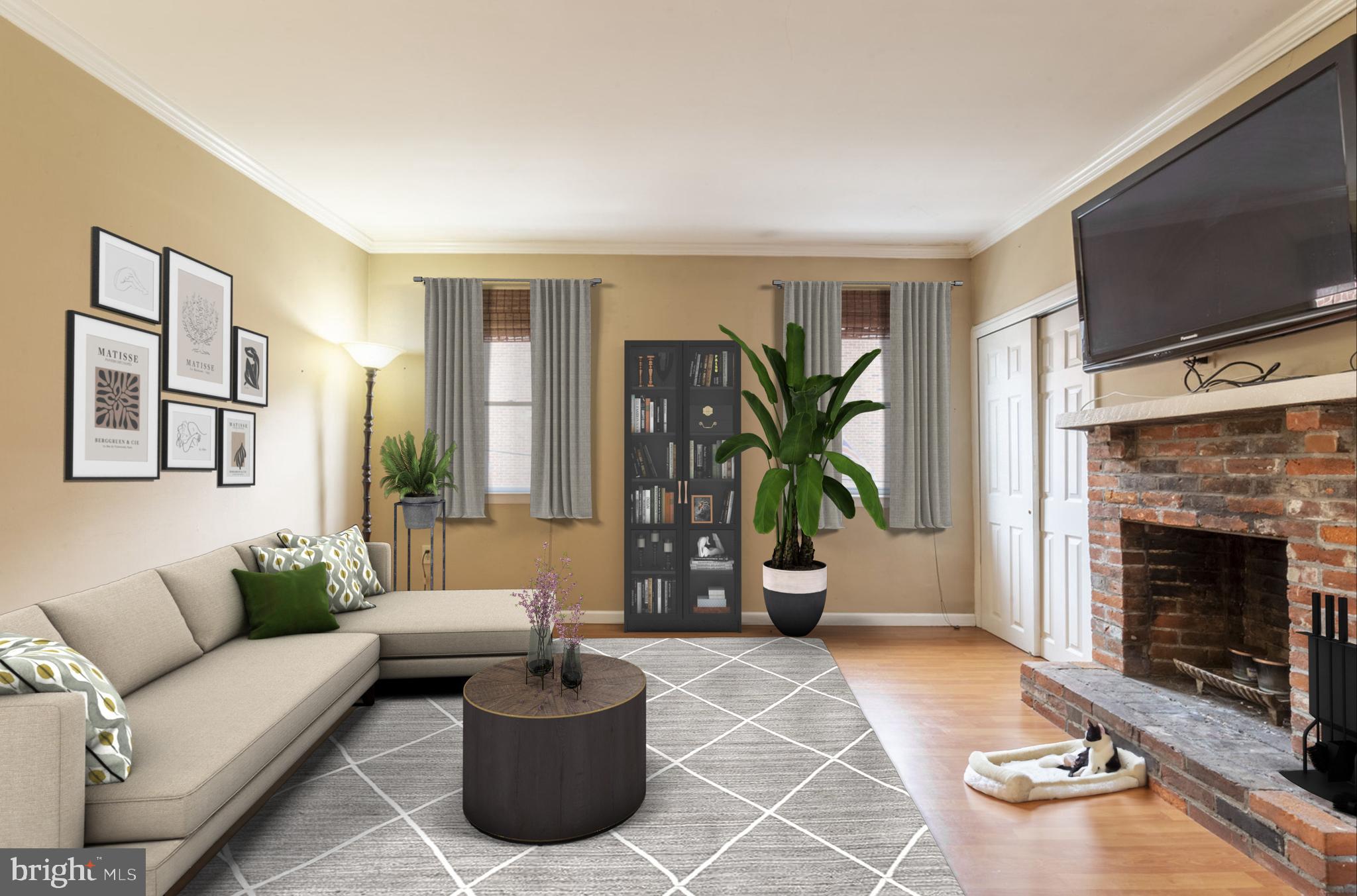 a living room with furniture a flat screen tv and a fireplace