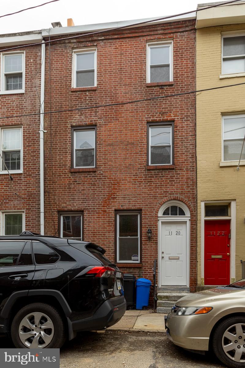 1120 Rodman Street, Unit 2 Philadelphia, PA 19147 - Photo 18 of 18 a car parked in front of a brick house