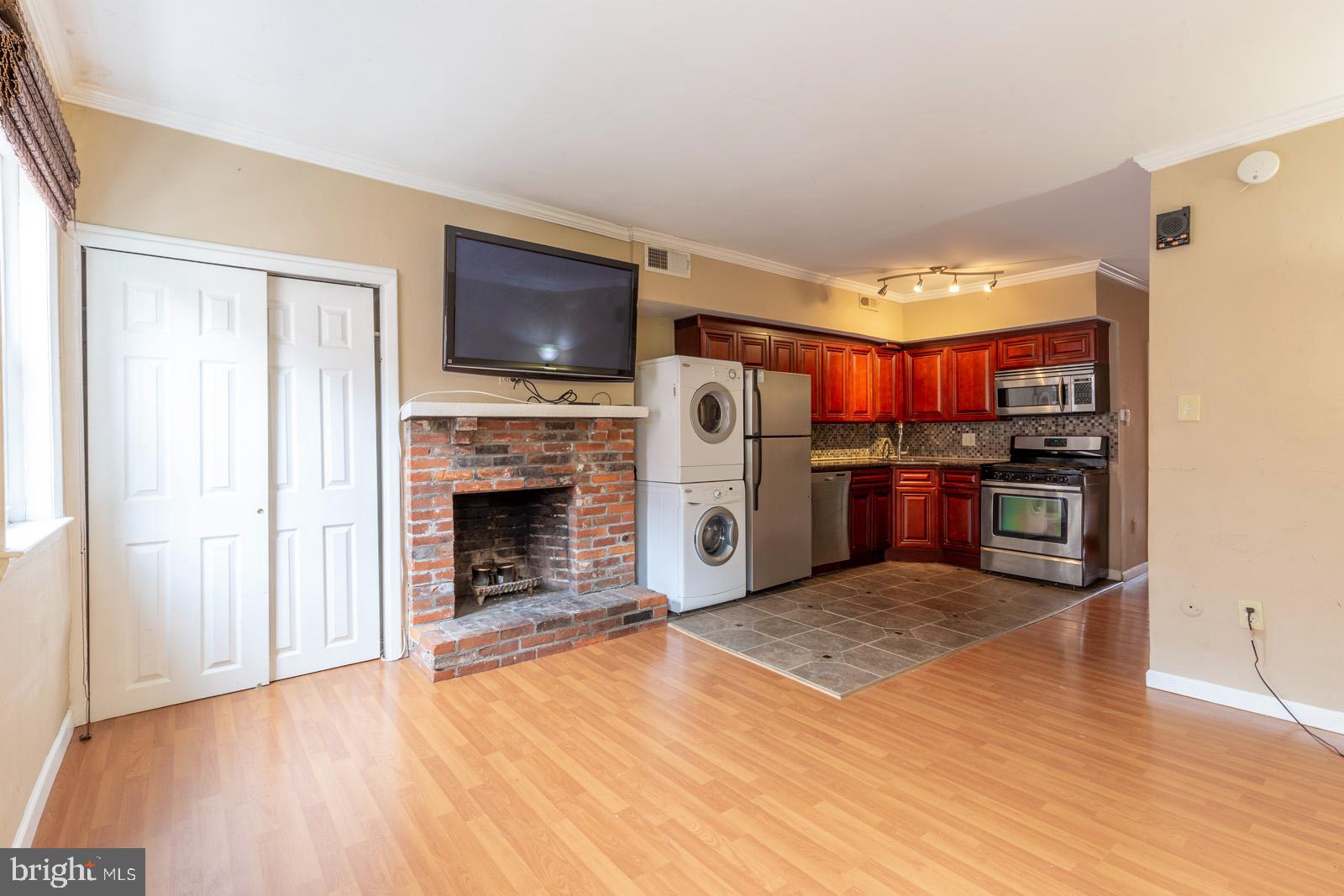 1120 Rodman Street, Unit 2 Philadelphia, PA 19147 - Photo 2 of 18 a living room with stainless steel appliances furniture a fireplace and a flat screen tv