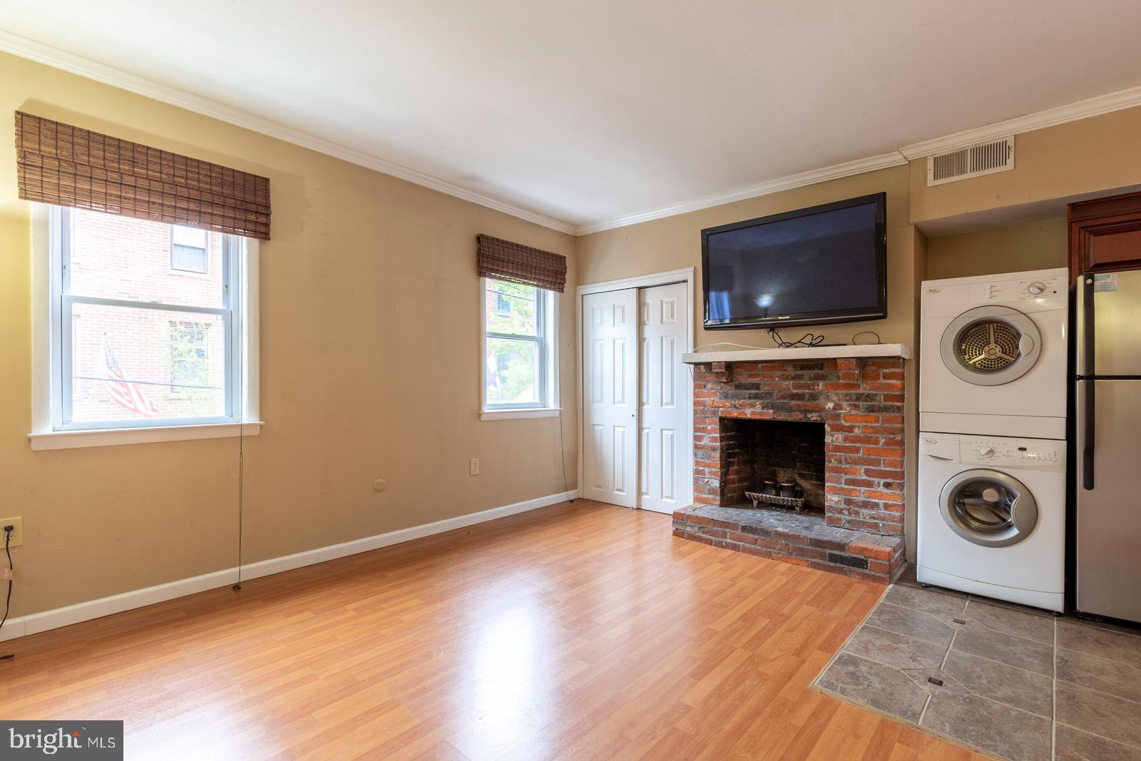 1120 Rodman Street, Unit 2 Philadelphia, PA 19147 - Photo 3 of 18 a view of livingroom with furniture a flat screen tv and a fireplace