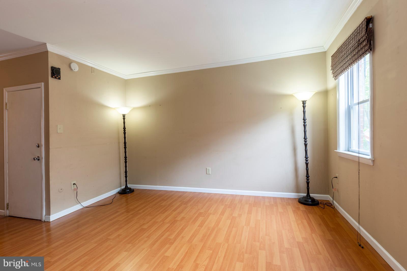 1120 Rodman Street, Unit 2 Philadelphia, PA 19147 - Photo 4 of 18 an empty room with wooden floor and windows