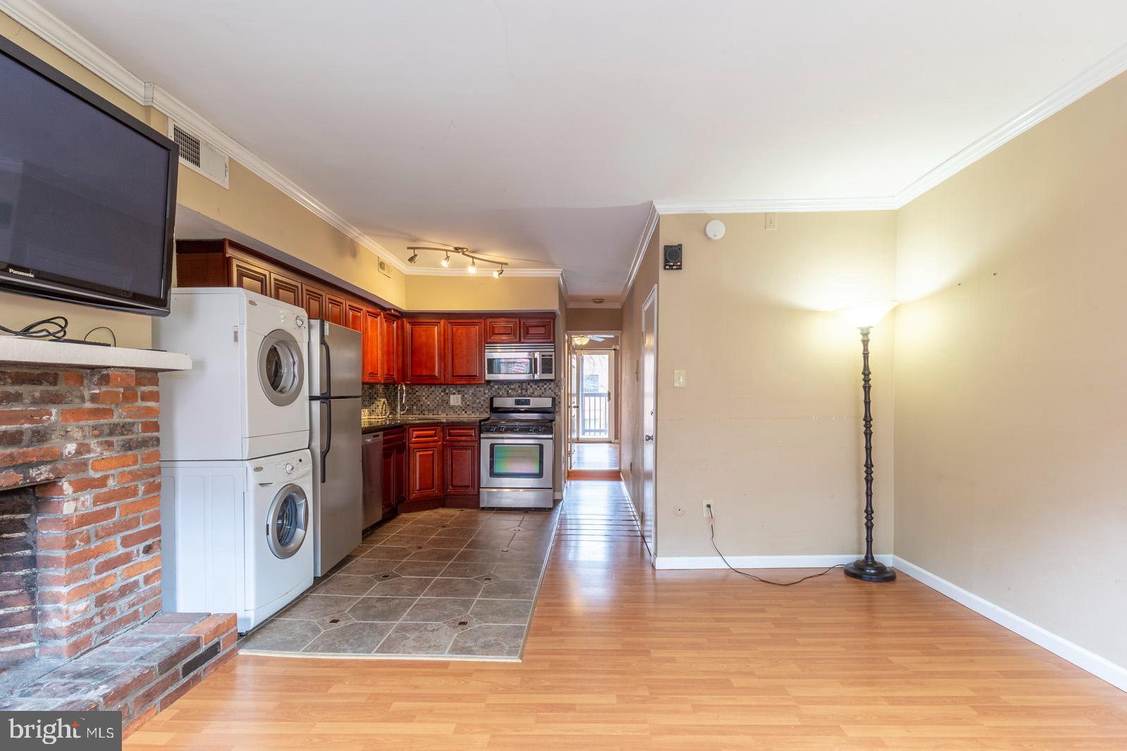 1120 Rodman Street, Unit 2 Philadelphia, PA 19147 - Photo 5 of 18 a view of a kitchen with a sink and a refrigerator