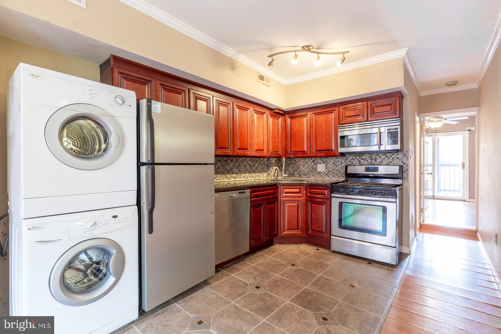 1120 Rodman Street, Unit 2 Philadelphia, PA 19147 - Photo 6 of 18 a kitchen with a refrigerator and a stove top oven
