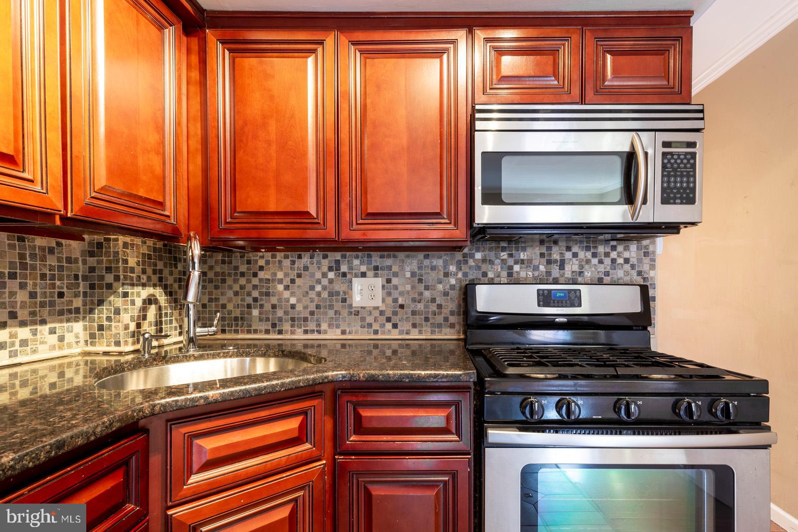 1120 Rodman Street, Unit 2 Philadelphia, PA 19147 - Photo 7 of 18 a kitchen with granite countertop a stove sink and microwave