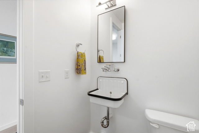 1295 North Canyon View Road Midway, UT 84049 - Photo 15 of 52 Wall-mounted basin sink with a black edge, chrome faucet, and rectangular mirror