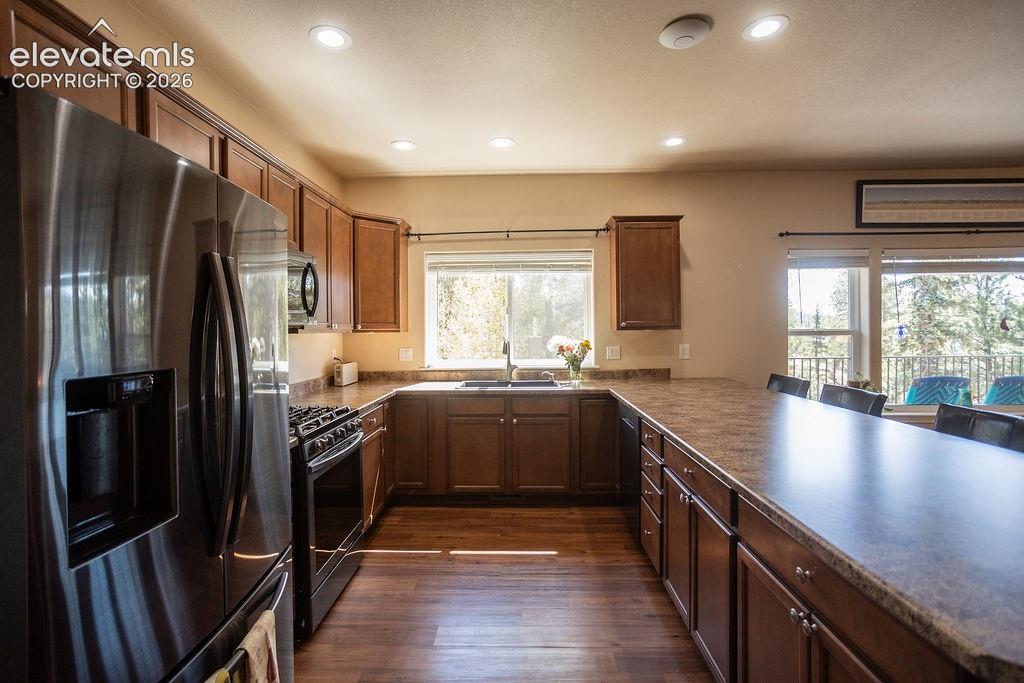 45 Valley Circle Divide, CO 80814 - Photo 9 of 42 a kitchen with stainless steel appliances granite countertop a refrigerator a sink and a stove
