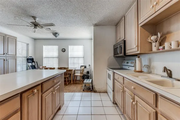 a kitchen that has a sink and a stove in it