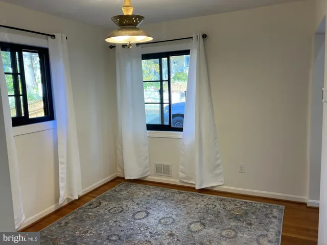 a view of a livingroom with a ceiling fan and window