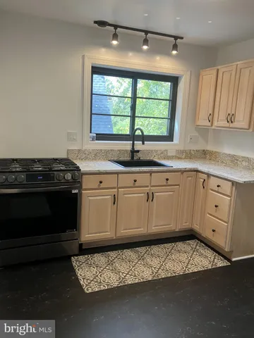 a kitchen with a sink stove and cabinets