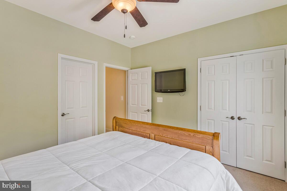 2720 Emmanuel Church Road Huntingtown, MD 20639 - Photo 30 of 85 a bedroom with a bed and a flat screen tv
