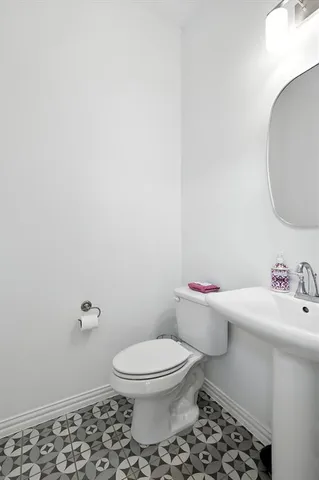 a white toilet sitting next to a bathroom sink